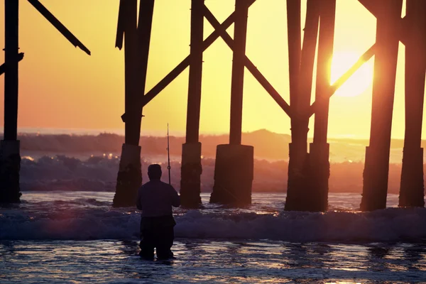 Sunrise fishing by the pier — Stock Photo, Image