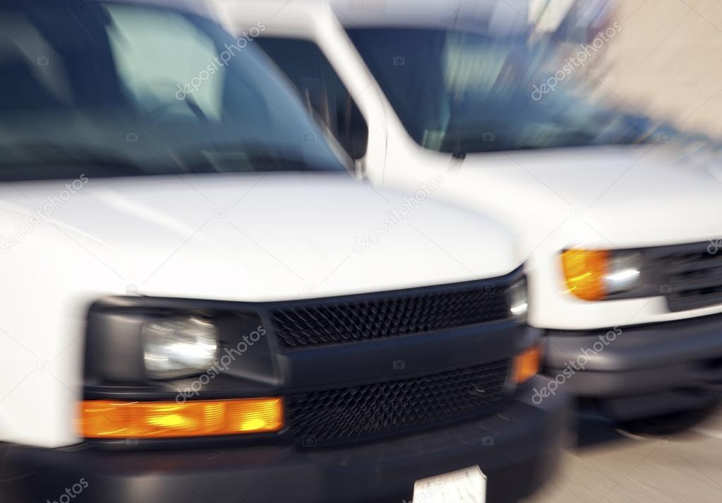 Two blurred vans