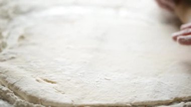 Kadın hamur yoğurmayı elleriyle yoğurur ve makarna yapar.