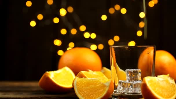 Кілька Скибочок Цілий Апельсин Сік Наливаються Склянку Блискавками Задньому Плані — стокове відео