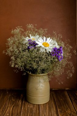 Bouquet in the vase on the table. Flowers in a vase. Summer bouquet. Wildflowers