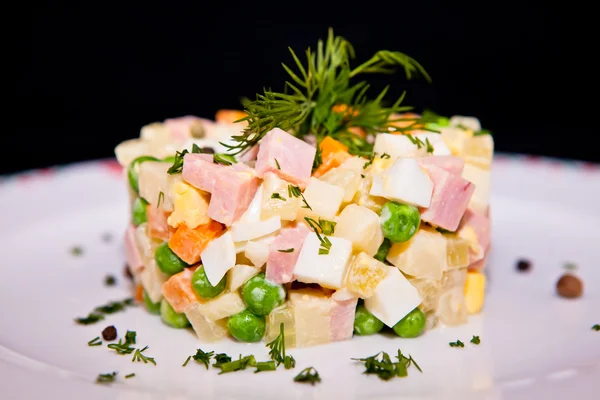 Russian traditional salad Olivier, isolated on black — Stock Photo, Image