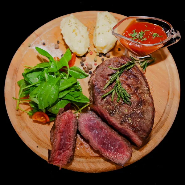 Grilled steak with potatoes, salad and ketchup — Stock Photo, Image