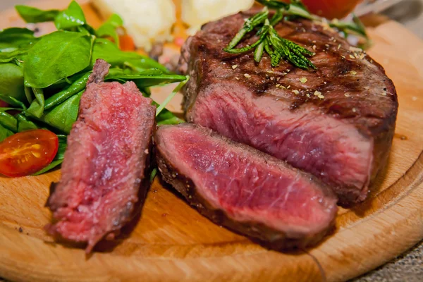 Grilled steak with potatoes, salad and ketchup — Stock Photo, Image