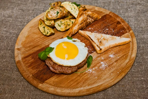 Roerei op vlees met gebakken aardappelen en toast — Stockfoto