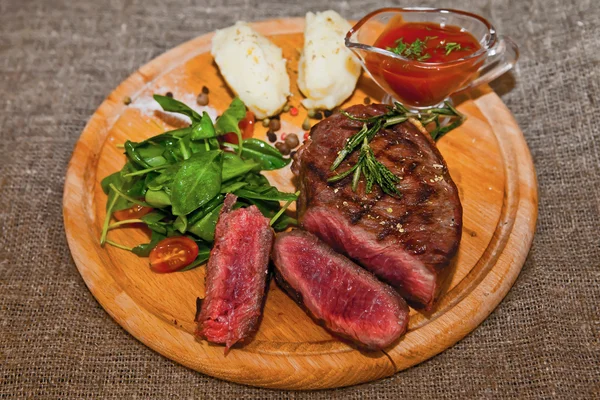 Grilled steak with potatoes, salad and ketchup — Stock Photo, Image