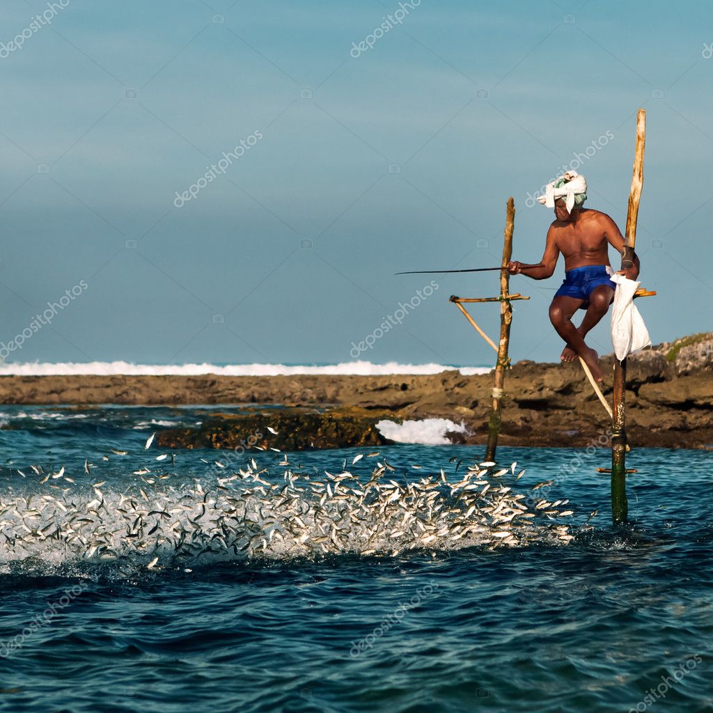 The local fishermen are fishing in unique style. The standing on the single  timber pole can only found in this Indian ocean Stock Photo - Alamy