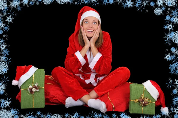 Surprised girl in santa costume with presents — Stock Photo, Image