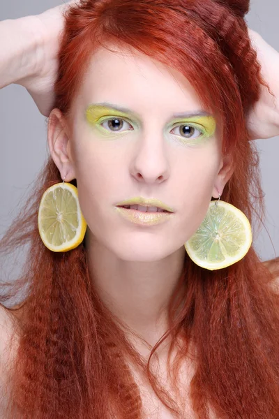 Portrait of woman with lemon slices in ears — Stock Photo, Image