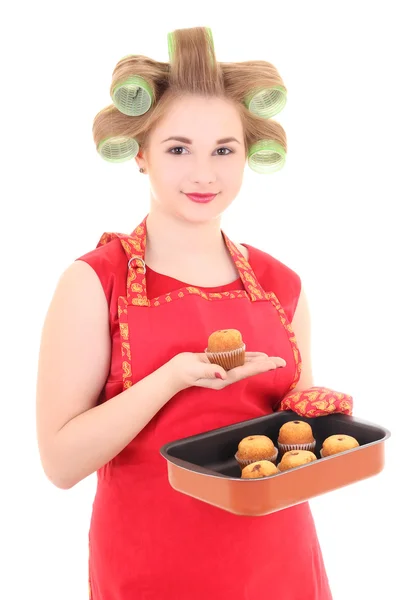 Funny housewife with hair curlers and muffins over white — Stock Photo, Image