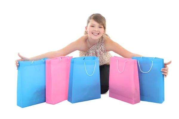 Tiener meisje met shopping tassen over wit — Stockfoto