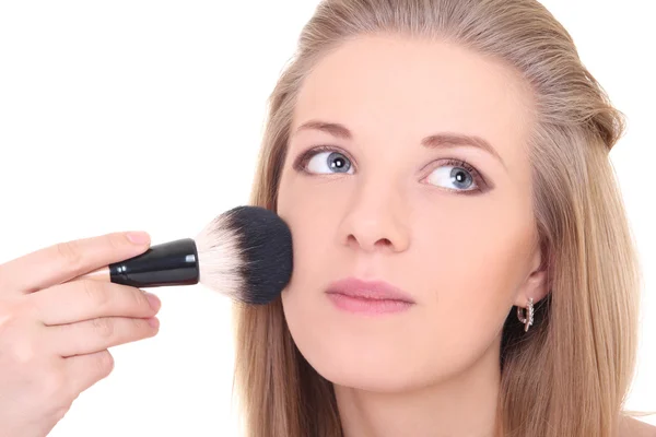 Young attractive woman with make-up brush over white — Stock Photo, Image