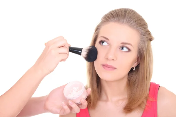 Young attractive blonde with make-up brush over white — Stock Photo, Image