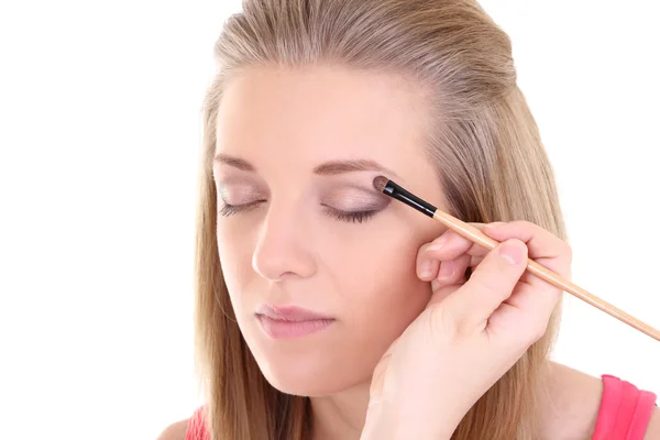 Young blonde with make-up brush over white — Stock Photo, Image