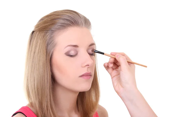Beautiful girl with make-up brush over white — Stock Photo, Image