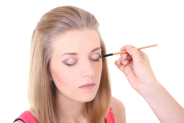 Beautiful blondie girl with make-up brush over white — Stock Photo, Image