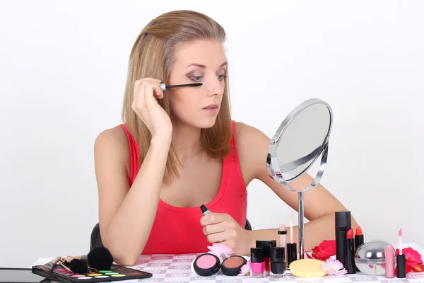 Beautiful woman with make up accessories and mirror — Stock Photo, Image