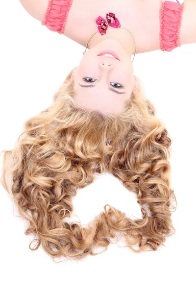 Young woman with long curly hair lying in the form of heart — Stock Photo, Image