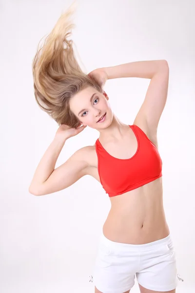 Athlete woman with long blowing hair over white — Stock Photo, Image