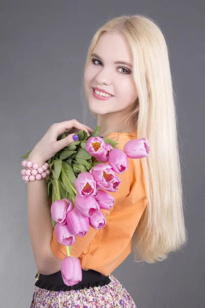 Portrait of beautiful blondie girl with tulips — Stock Photo, Image