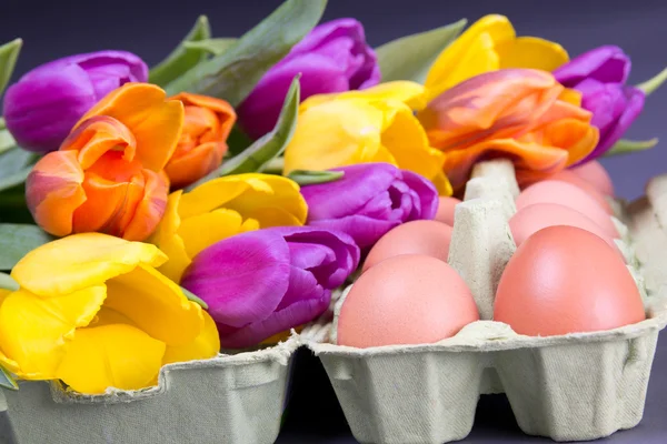 Easter eggs with colorful tulips — Stock Photo, Image