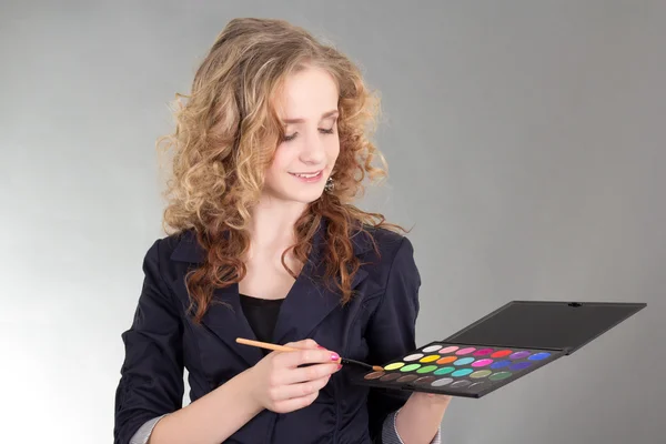 Young beautiful woman with make up brushes and palette — Stock Photo, Image