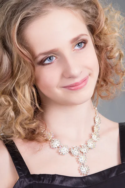 Close up portrait of young curly woman with necklace — Stock Photo, Image