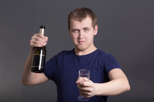 Young drunk man with bottle of champagne and glass — Stock Photo, Image