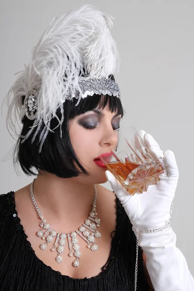Beautiful vintage actress drinking cognac — Stock Photo, Image