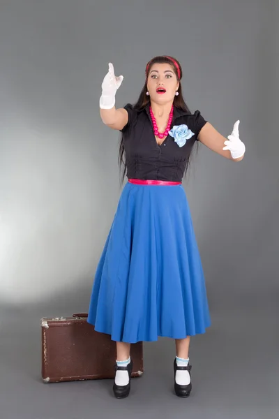 Worried pinup girl with suitcase — Stock Photo, Image