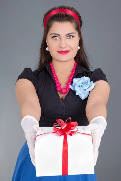 Beautiful pinup girl giving a present — Stock Photo, Image