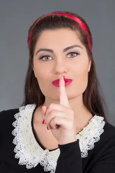 Portrait of young attractive maid with finger on her lips — Stock Photo, Image