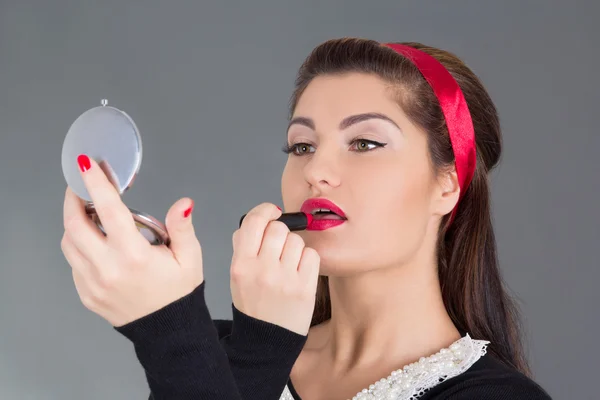 Pinup girl with red lipstick and mirror — Stock Photo, Image
