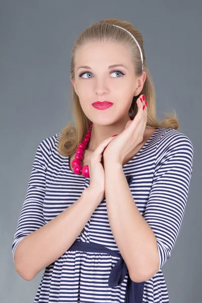 Dreaming pinup girl in striped dress posing — Stock Photo, Image