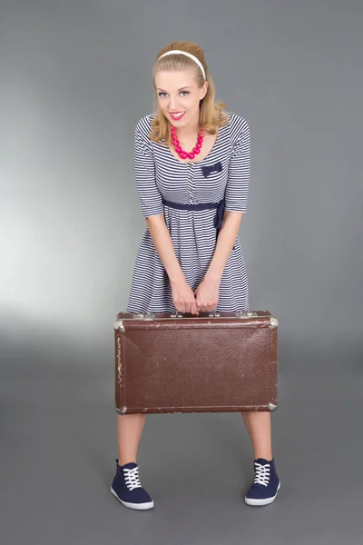 Pinup girl with brown retro suitcase — Stock Photo, Image