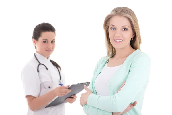 Young female patient and doctor with folder isolated over white — Stockfoto