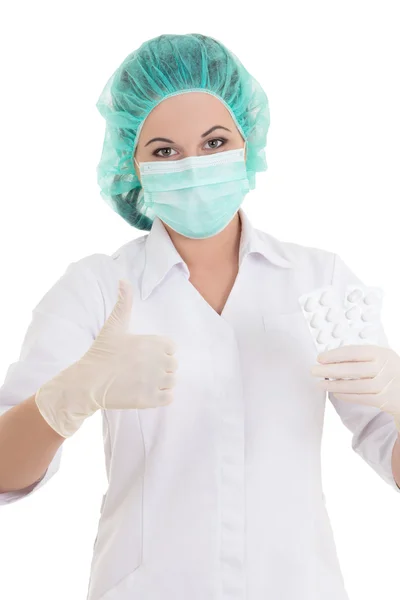 Portrait of young doctor in mask with pills thumbs up — Stock Photo, Image