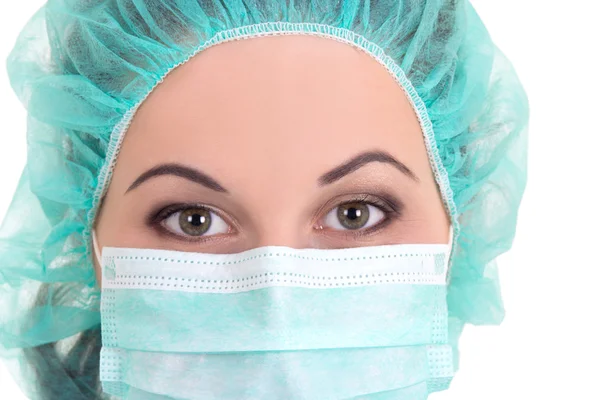 Close up portrait of female doctor in blue mask and cap over whi — Stock Photo, Image