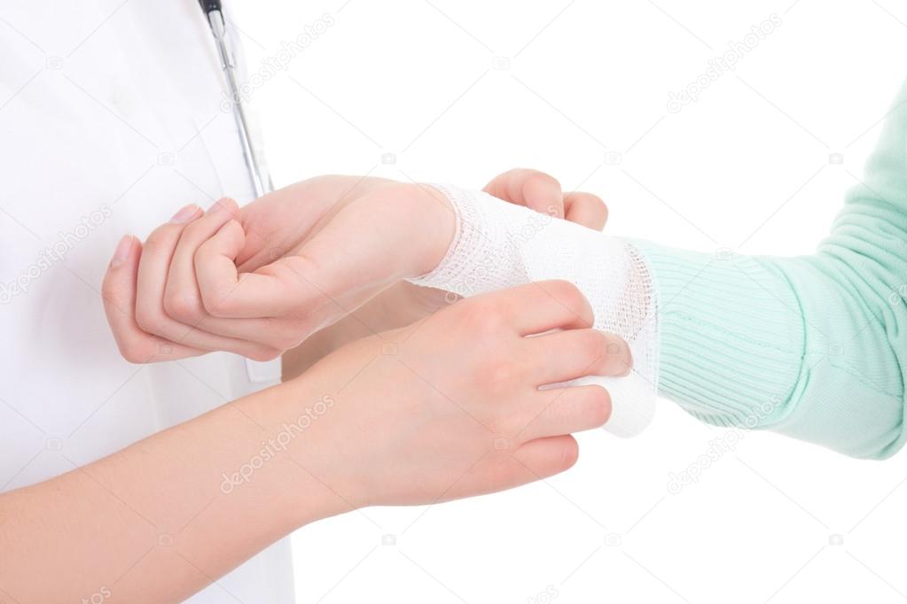doctor bandaging female hand over white