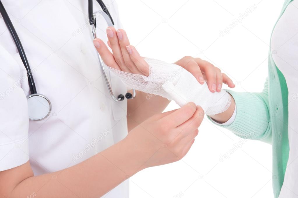 doctor bandaging female hand over white background