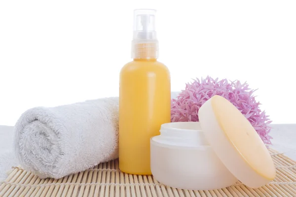 Lotion and cream with towel — Stock Photo, Image