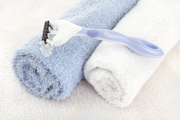 Blue blade over fresh towels — Stock Photo, Image