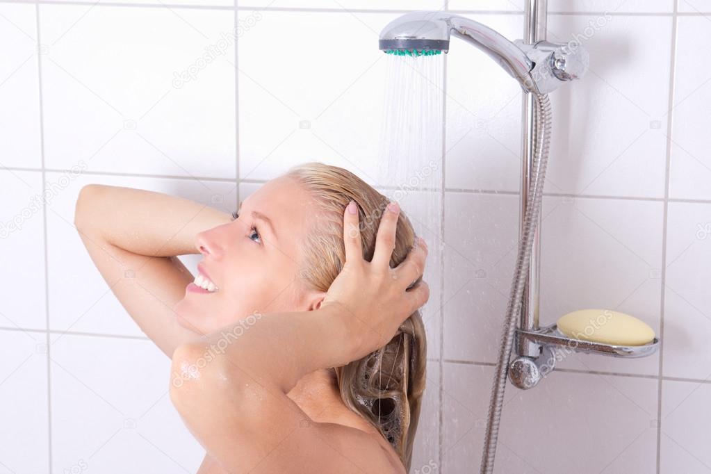 blondie woman washing long hair in shower