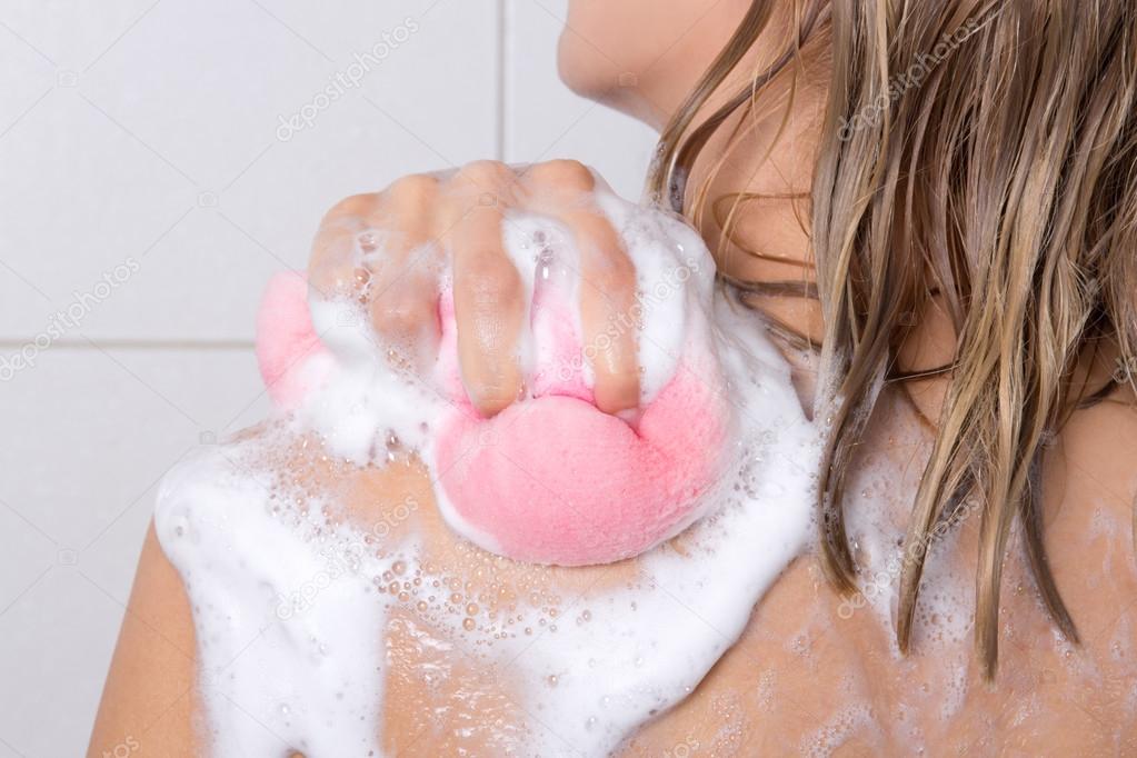 sexy blondie woman washing her shoulders