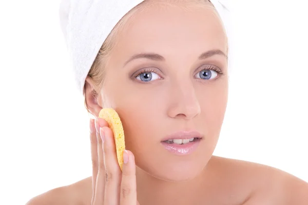 Young beautiful woman with sponge washing her face — kuvapankkivalokuva