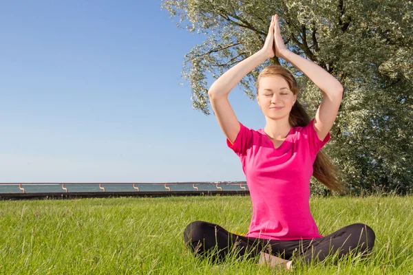 Young woman in lotus pose — Stock Photo, Image