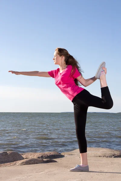 Girl in sportswear trainig near the sea — Stock Photo, Image