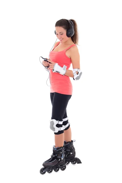 Beautiful woman in roller skates listening music on white backgr — Stock Photo, Image