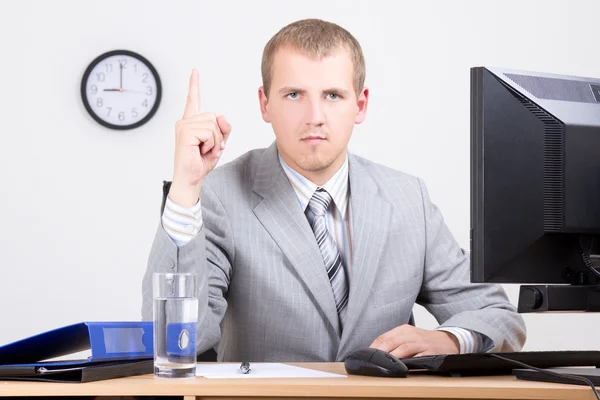 Young man with business idea sitting in office — Stock Photo, Image