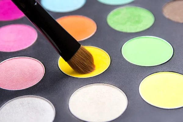 Close up of Make-up brush and colorful eyeshadow palette over bl — Stock Photo, Image